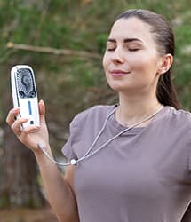 Woman using Arctic Air® Pocket outside with strap around her neck